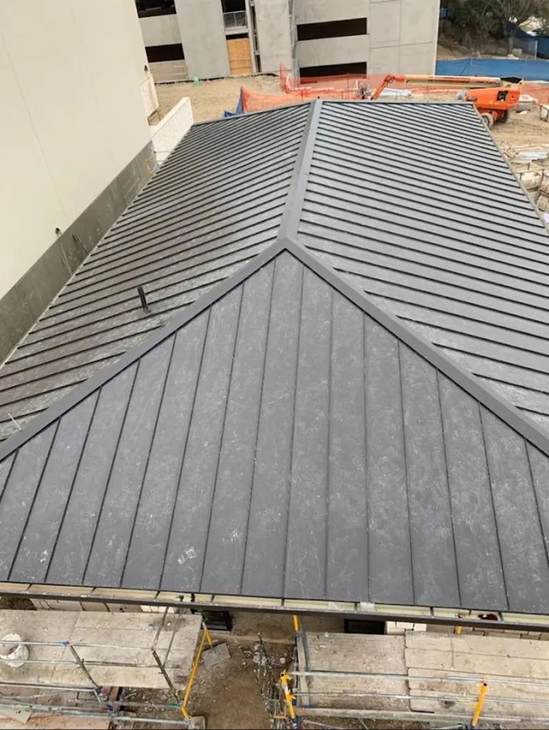 Commercial metal roof construction with crane equipment in Strawberry